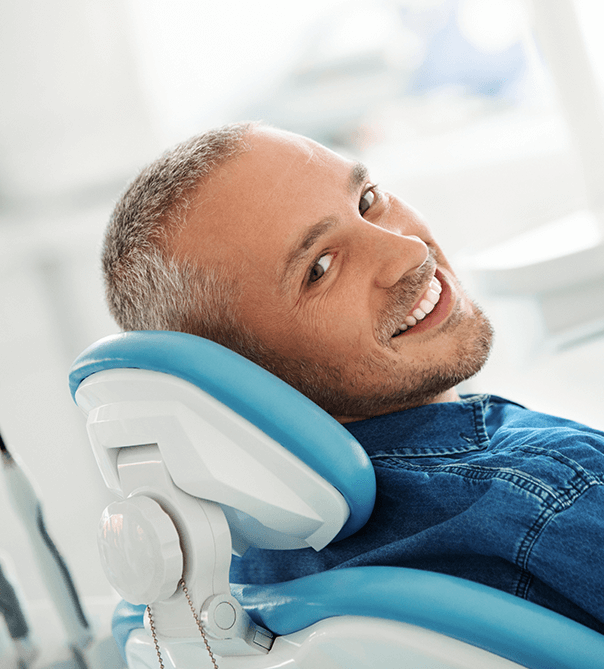 man with short gray hair sitting in dental chair