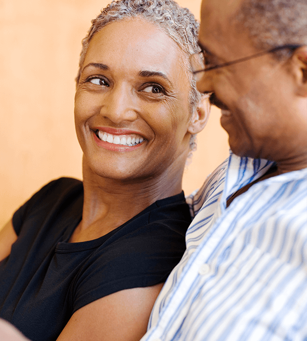 older black couple smiling at each other