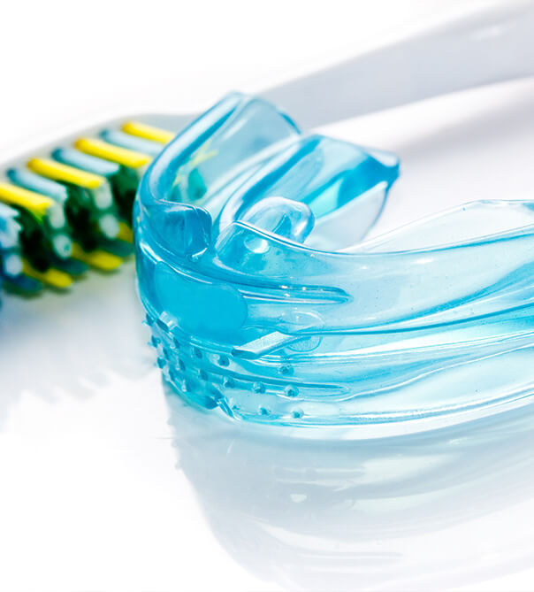 closeup of mouthguard and toothbrush