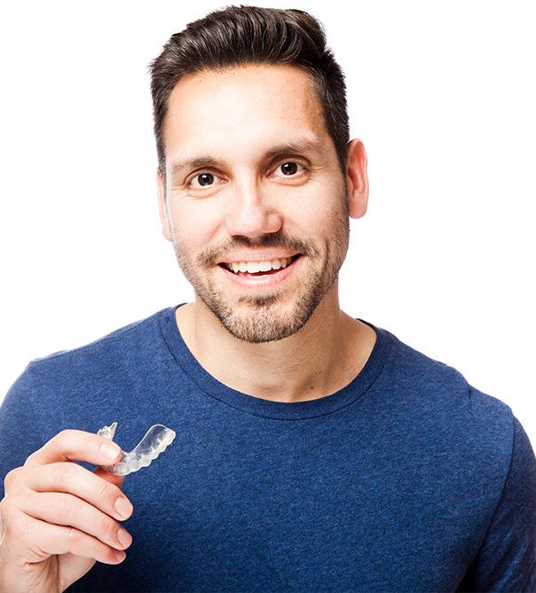 Man holding a clear aligner